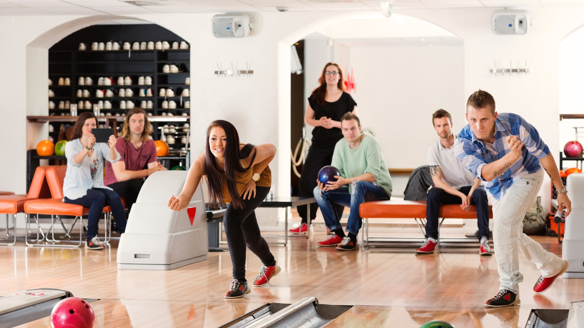 Bowling team cheering together at the alley