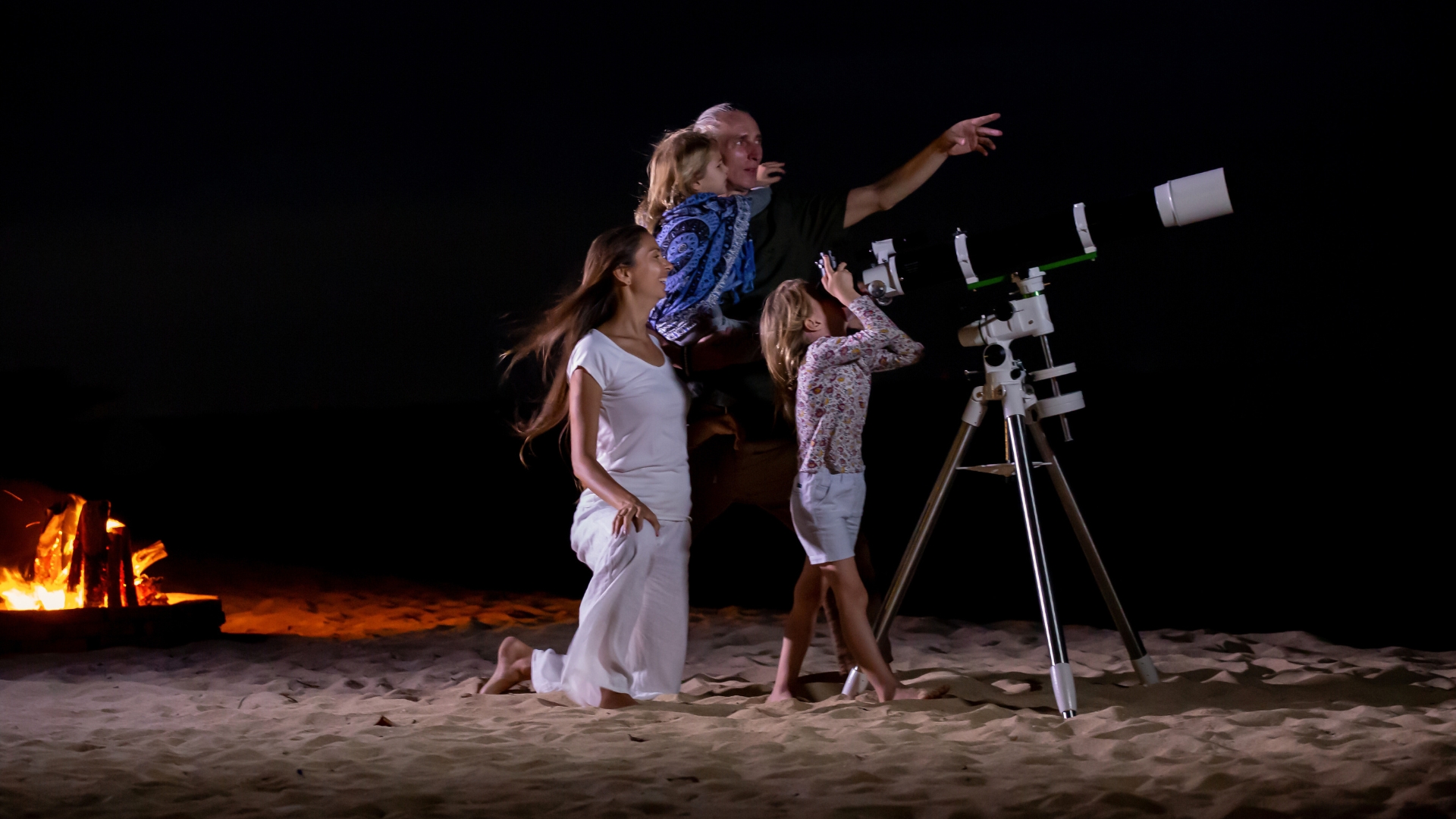 Family observing starry night sky symbolizing exploration and legacy