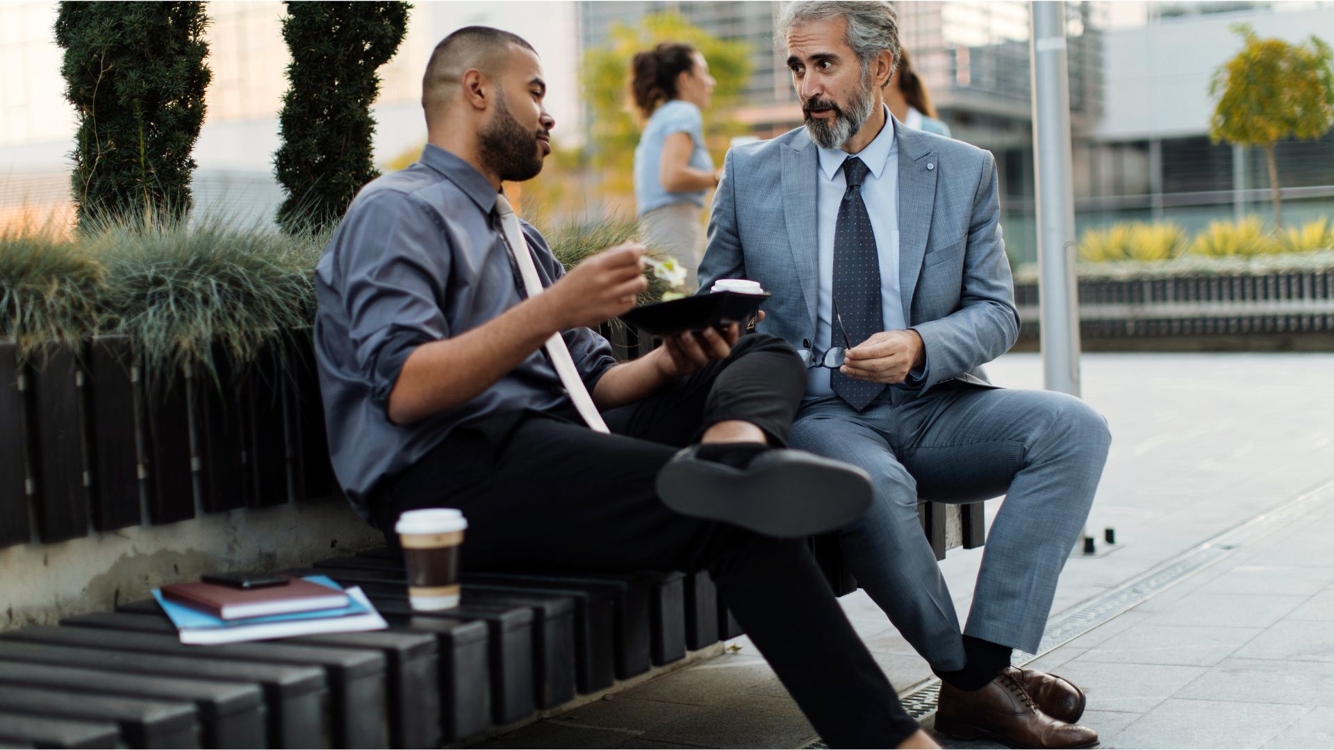Mentor guiding a young professional during a one-on-one discussion.