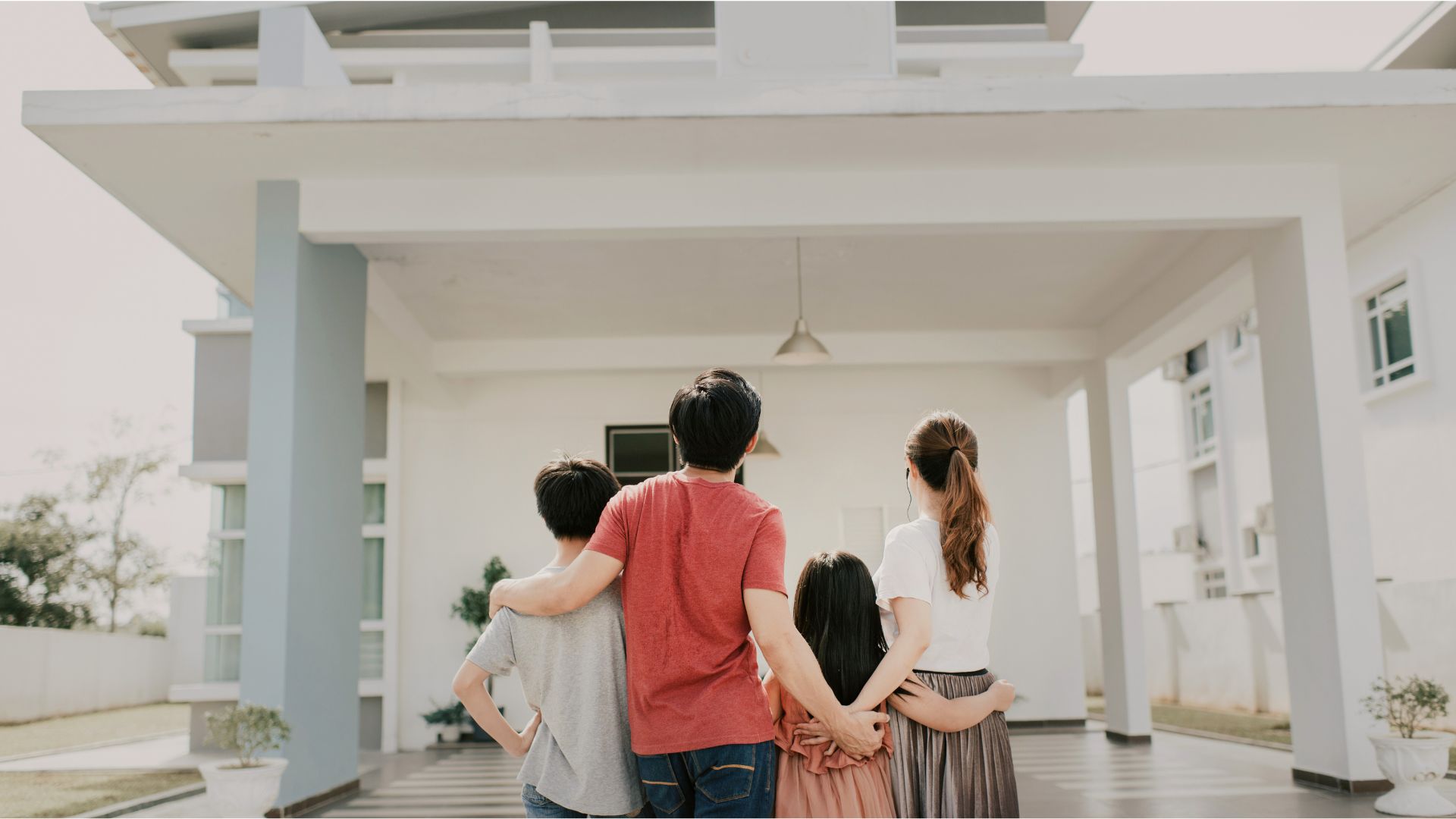A family standing outside their home, symbolizing protection of family homes and generational wealth through estate planning in Wisconsin