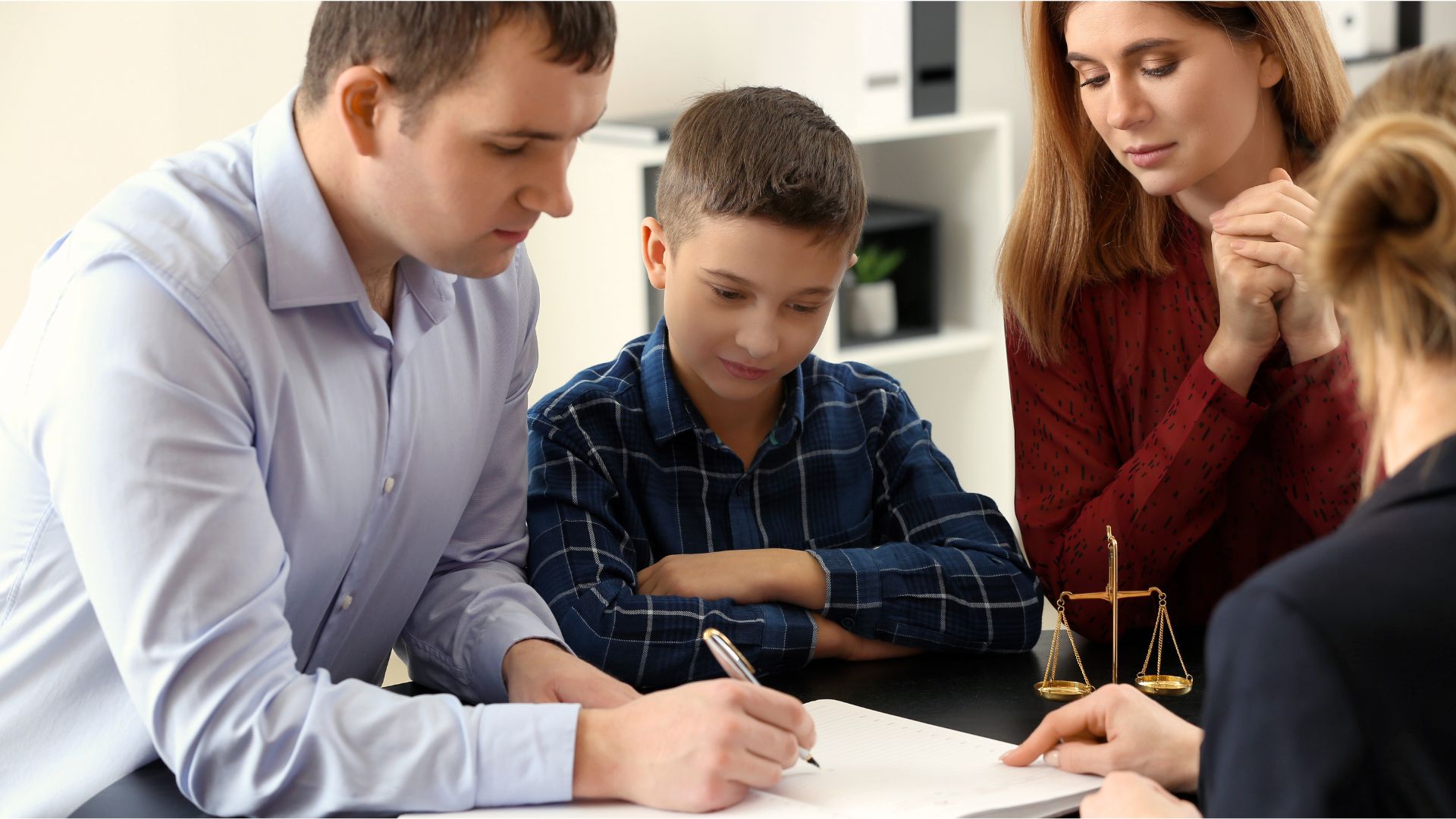 Attorney reviewing probate documents with a family in an office setting, guiding them through complex Wisconsin probate procedures.