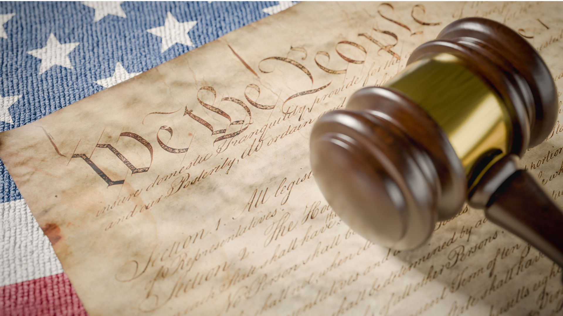 The United States Bill of Rights displayed alongside the American flag, symbolizing the enduring importance of constitutional freedoms today.