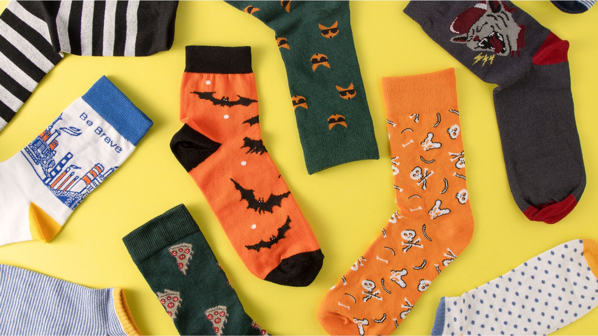 Colorful socks laid out on a cozy floor with warm lighting, celebrating the history and everyday comfort of socks.