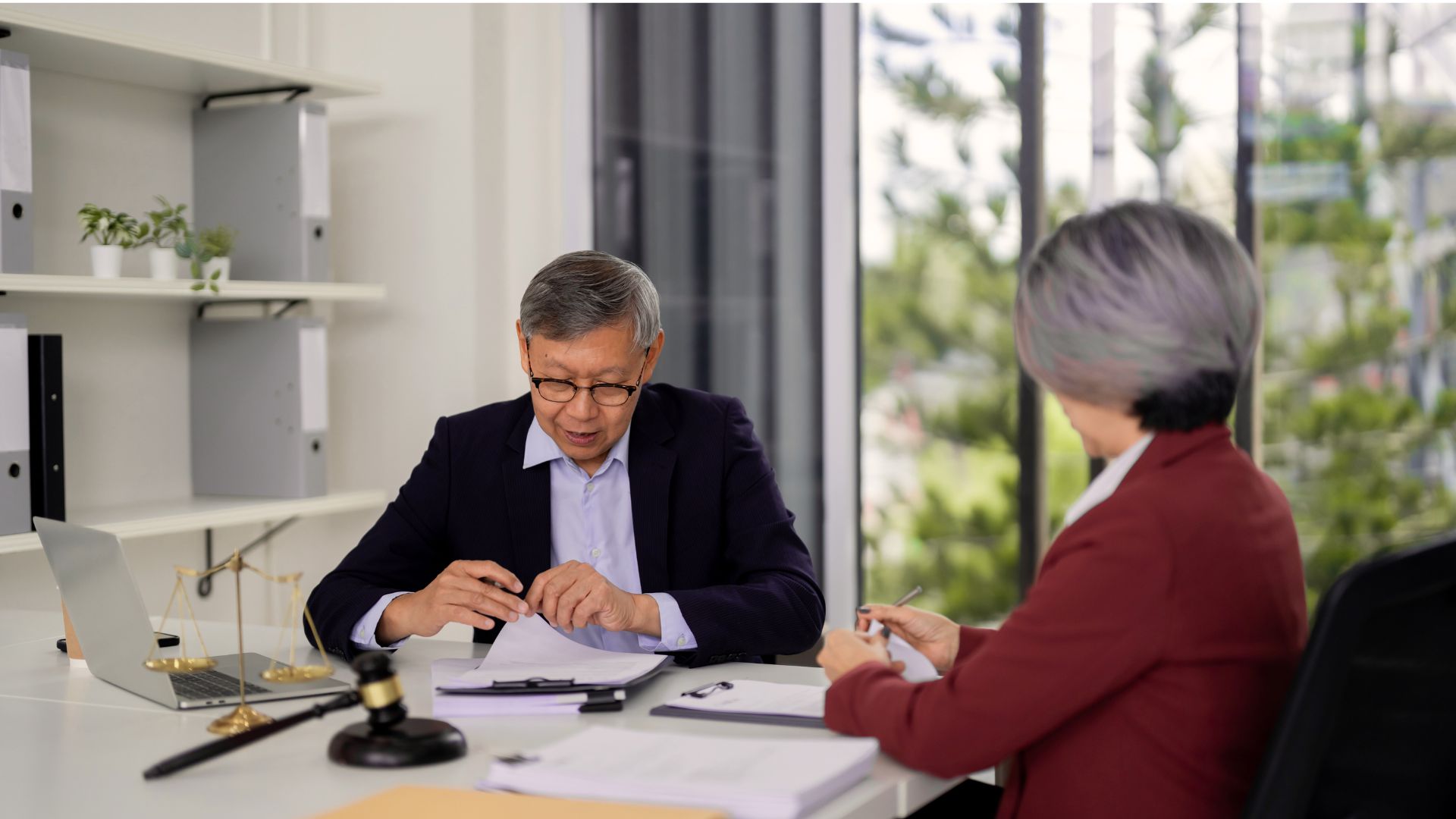 Retiree reviewing Power of Attorney documents with an attorney in Madison, emphasizing the importance of annual updates for legal and financial security.
