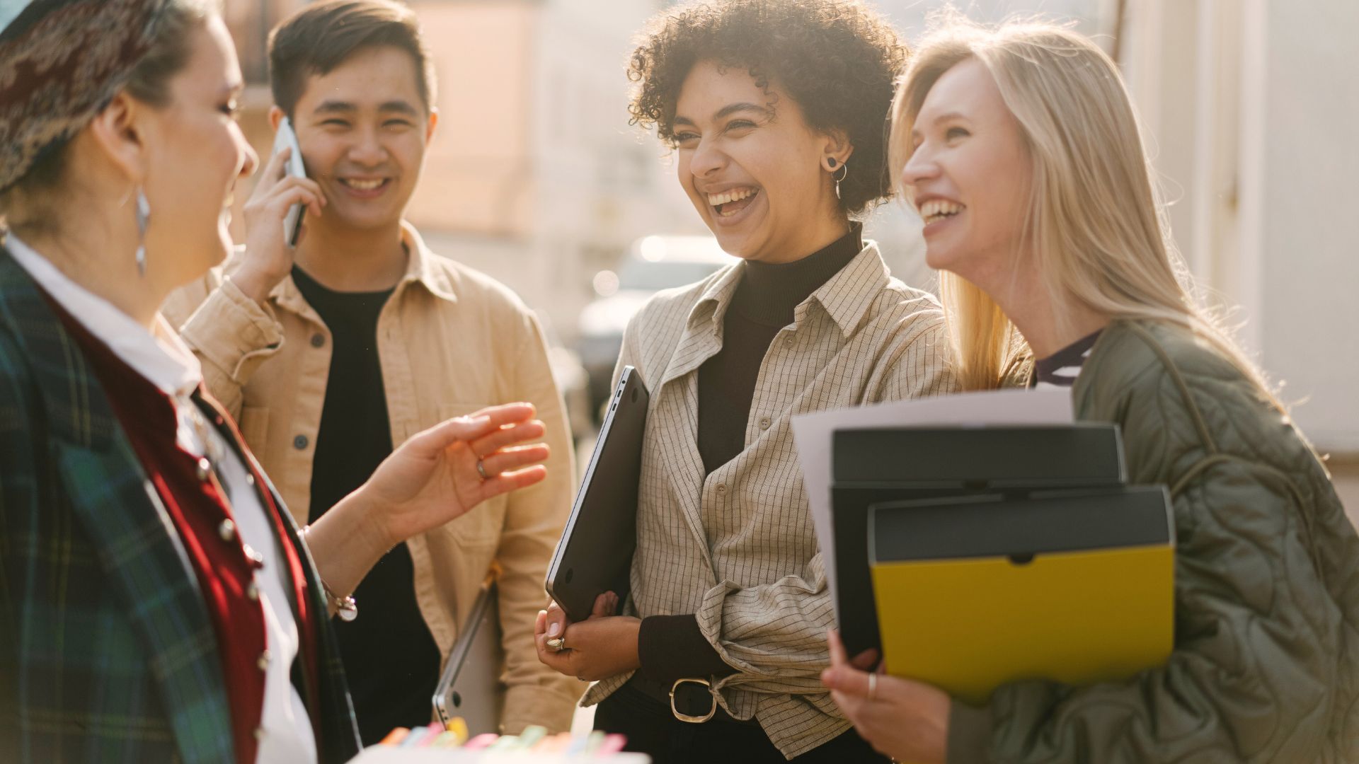 People smiling and sharing positive moments together, symbolizing how joy and kindness spread within a community.